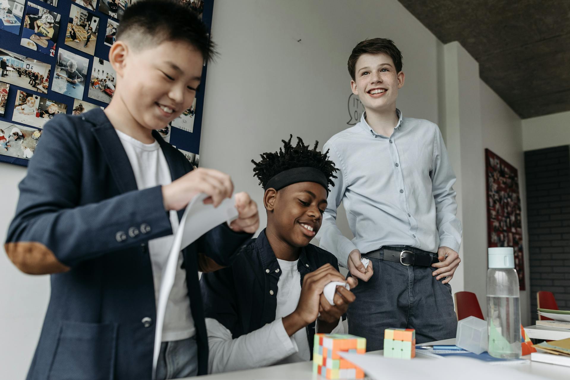 Laughing cheery smiling children and teens having fun inside doing arts and crafts